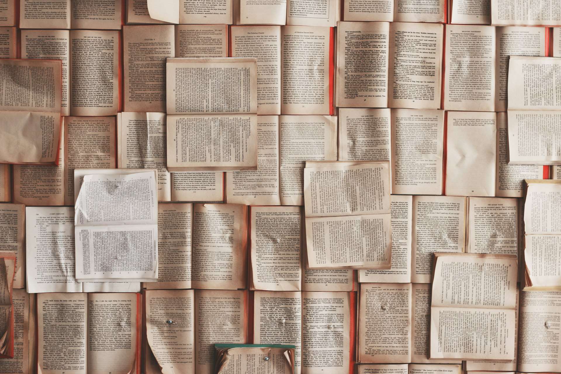 A wall covered in open book pages
